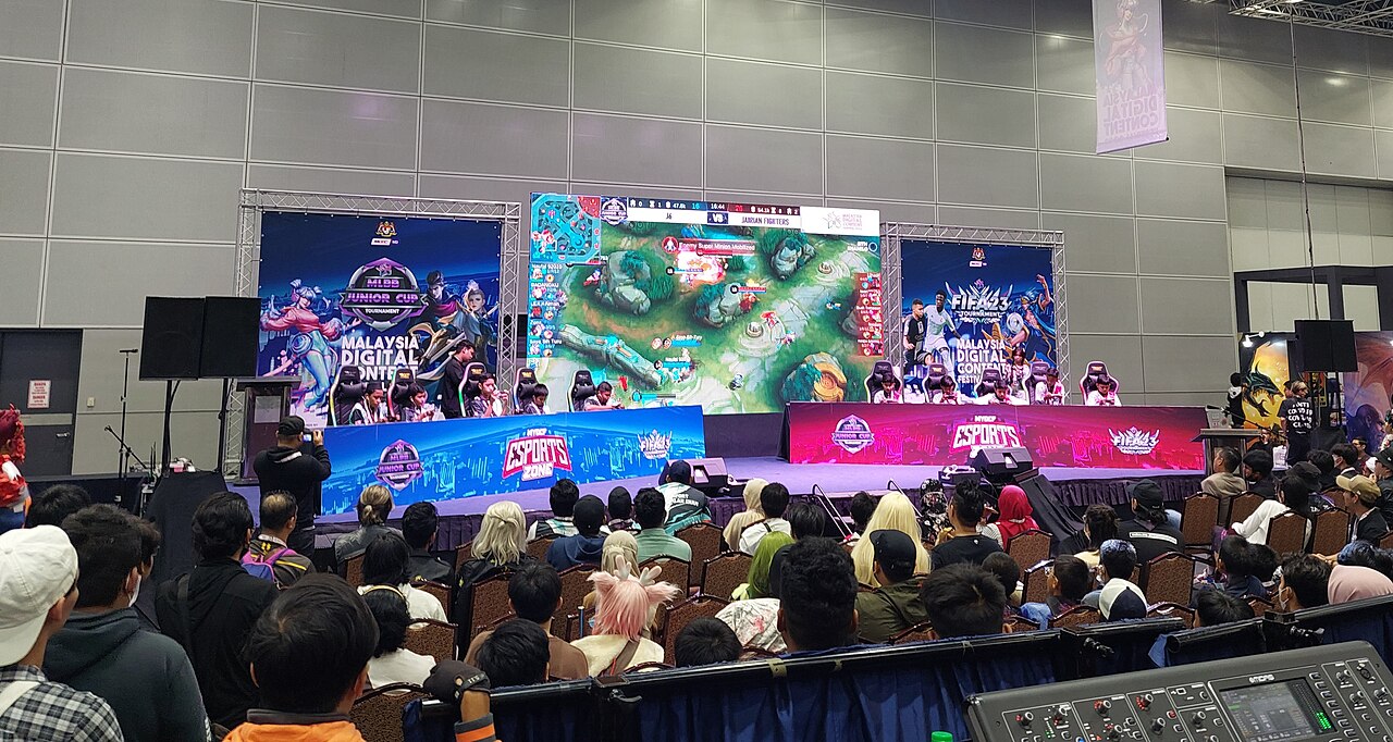 Audience watching a mobile esports match on big screens