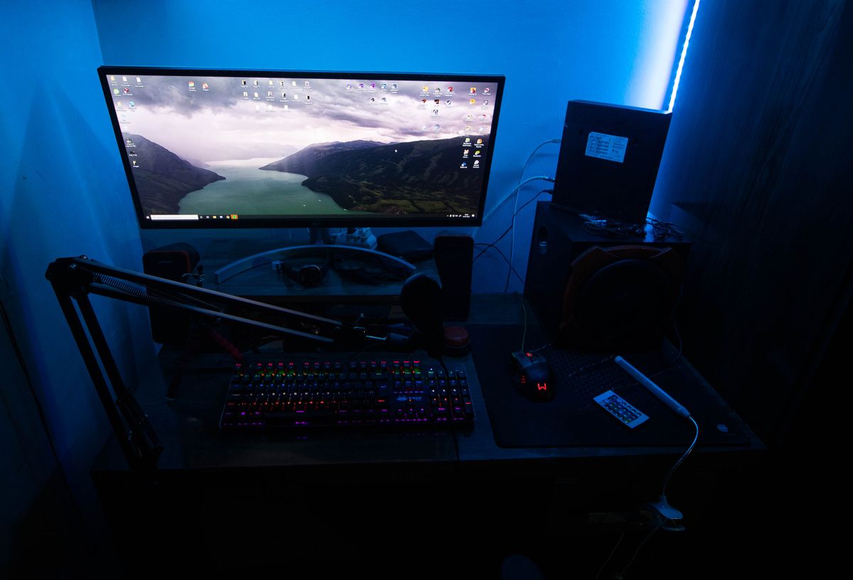 Gaming desk with monitor and blue ambient lighting